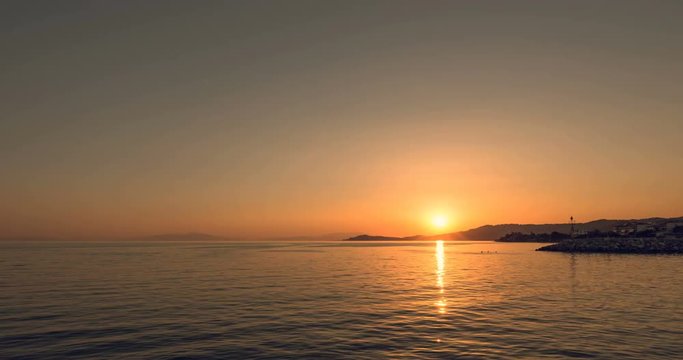 Sunset in Nea Skioni town, peninsula Kassandra, Greece. Time lapse of sunset on Aegean sea.