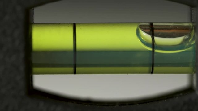 Leveling instrument's bubble closeup. Carpenter's spirit level macro. Buildings and construction level