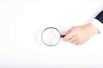 A man hand holding magnifying Glass on white background.