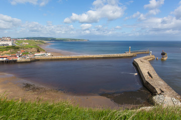 Whitby harbour entrance and coast North Yorkshire England uk