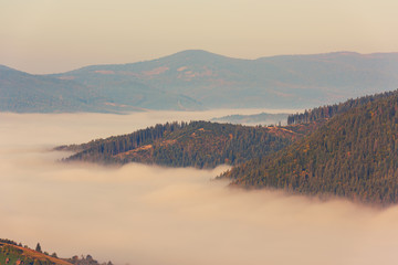 Foggy sunrise over the mountain ridge, autumn landscape, travel nature background