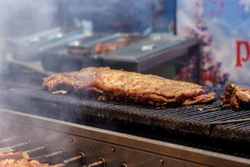 The process of cooking shish kebab on a metal grill in the open air.Grilling shashlik on barbecue grill. Marinated meat.