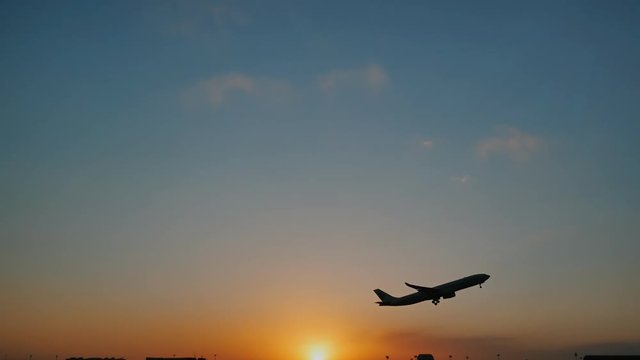 Plane taking off sky sunset sun dusk in airport China. Beijing.