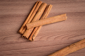 cinnamon sticks on wooden table.