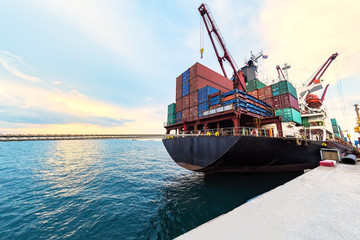 container ship commercial vessel alongside in port for loading and discharging containers services...