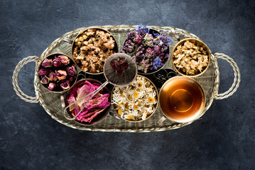 Dried medical healing herbs and herbal tea in a vintage basket