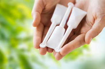 hand holding tubes of micro enema