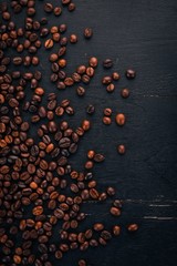 Coffee beans. On a wooden background. Top view. Copy space.