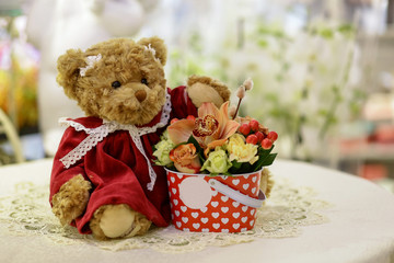 Toy teddy bear with a bouquet of flowers, background,Postcard, Valentine's Day, Women's Day