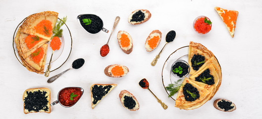Pancakes with caviar. On a wooden background. Top view. Free space for text.