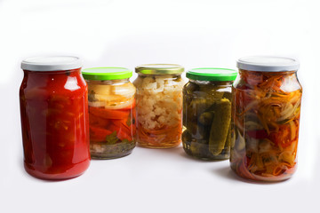 Fototapeta na wymiar Glass jars with different colorful canned salads isolated on white background