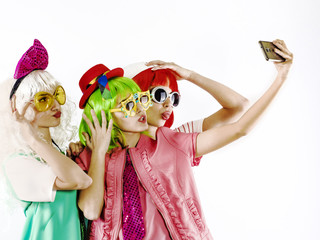 Cheerful maiden company makes selfies. White background.