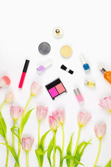 Flatlay with pink tulips, various makeup products, cosmetics and other beauty accessories. Concept of natural cosmetics and skincare, white background