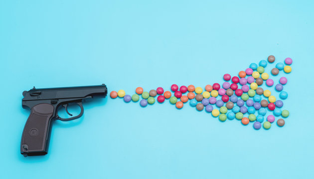 Pistol shooting sweets, applique artwork, shot from a gun aroma colored candies and jelly beans