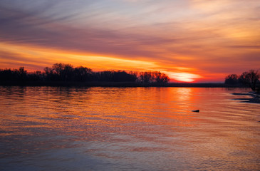 Beautiful landscape with sunset fiery sky and sea. Composition of Nature