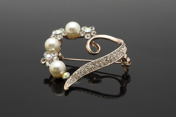 brooch heart with diamonds and pearls isolated on black