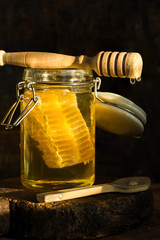 Honey in a jar with honey comb inside