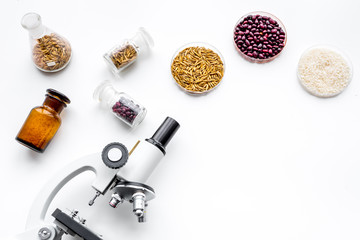 Food safety. Wheat, rice and red beans near microscope on white background top view copy space