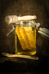 Honey in a jar with honey comb inside