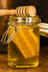 Honey in a jar with honey comb inside