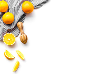 Freshly squeezed orange juice. Juicer and slices of oranges on white background top view copy space