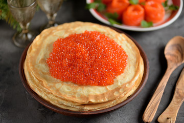 Classic Russian pancakes with red salmon caviar.