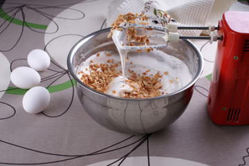 A bowl with whipped to solid peaks with sugar and peanuts