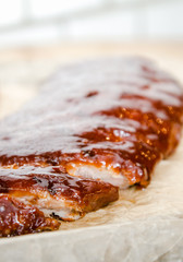 Close up view of barbecue ribs with fries and sauce on a old wooden table