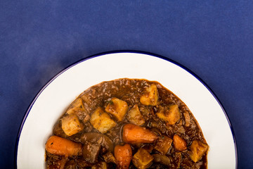 Beef and Red wine Casserole With Roast Potatoes Carrots and Mushrooms