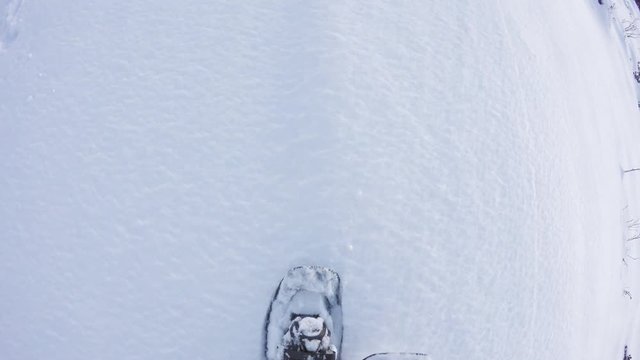 Overhead POV man hiking and walking with snowshoes outdoor on white snowy path in mountain wild field in winter. Detail of legs and shoes steps on snow.Point of view 4k video             