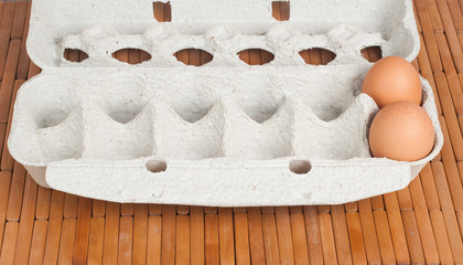 Brown eggs on wooden background