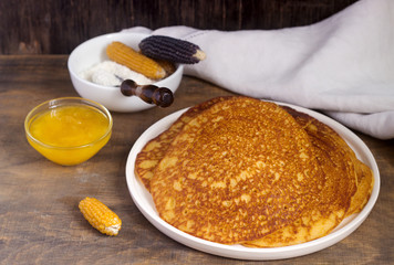 Coconut corn pancakes with honey. Rustic style.