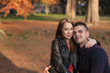 Lovely couple enjoying fall in love at park
