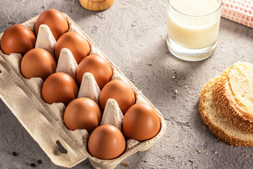 Farm raw fresh egg in pack bread milk on gray table scrambled eggs omelet fried egg