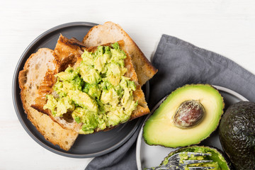 Healthy snack of avocado toasts from sourdough bread