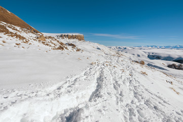 Fototapeta na wymiar The landscape of snow-covered Caucasian rocks on the Gumbashi Pass.