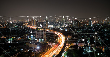 Night time city scape with connecting dots for networking and communication.