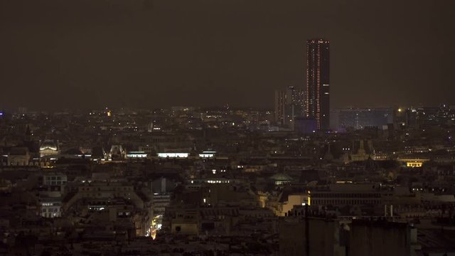 PARIS, FRANCE  – SEPTEMBER 2016 : Video shot of central Paris rooftops at night with view of tall buildings