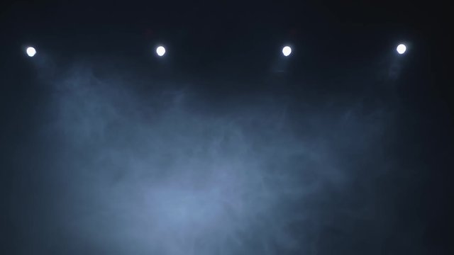 Smoke slowly floating through space against black background