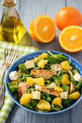 Grilled chicken fillet salad with oranges and brie.