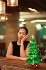 Dull black woman sitting at counter