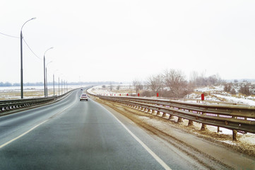 Winter track. The car is driving along the road.
