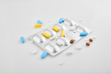Medicines - saving lives. Assorted pharmaceutical medicine pills, tablets and capsules on white background.