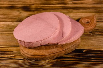 Sliced boiled sausage on a cutting board