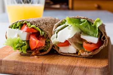 Low Calorie Diet Wrap with Cheese, Tomatoes, Salad and Orange Juice.