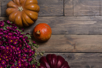 Autumn colors. Pumpkins on a wooden table. Textured background. Dark boards.