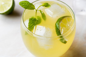 Yellow Lemonade Cocktail with Lime and ice.
