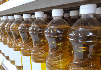 Fototapeta na wymiar plastic bottles of a vegetable oil on shelves