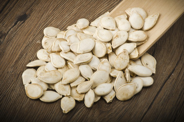 Dried pumpkin seeds on the wood table