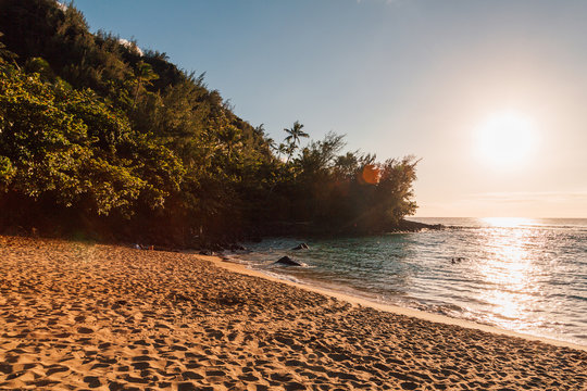 Beautiful sunset at the beach on the island of Kauai near Na Pali cliffs. Paradise island.